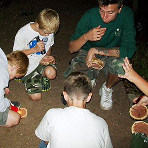 Cub Scouts with instructor studying tree cookies